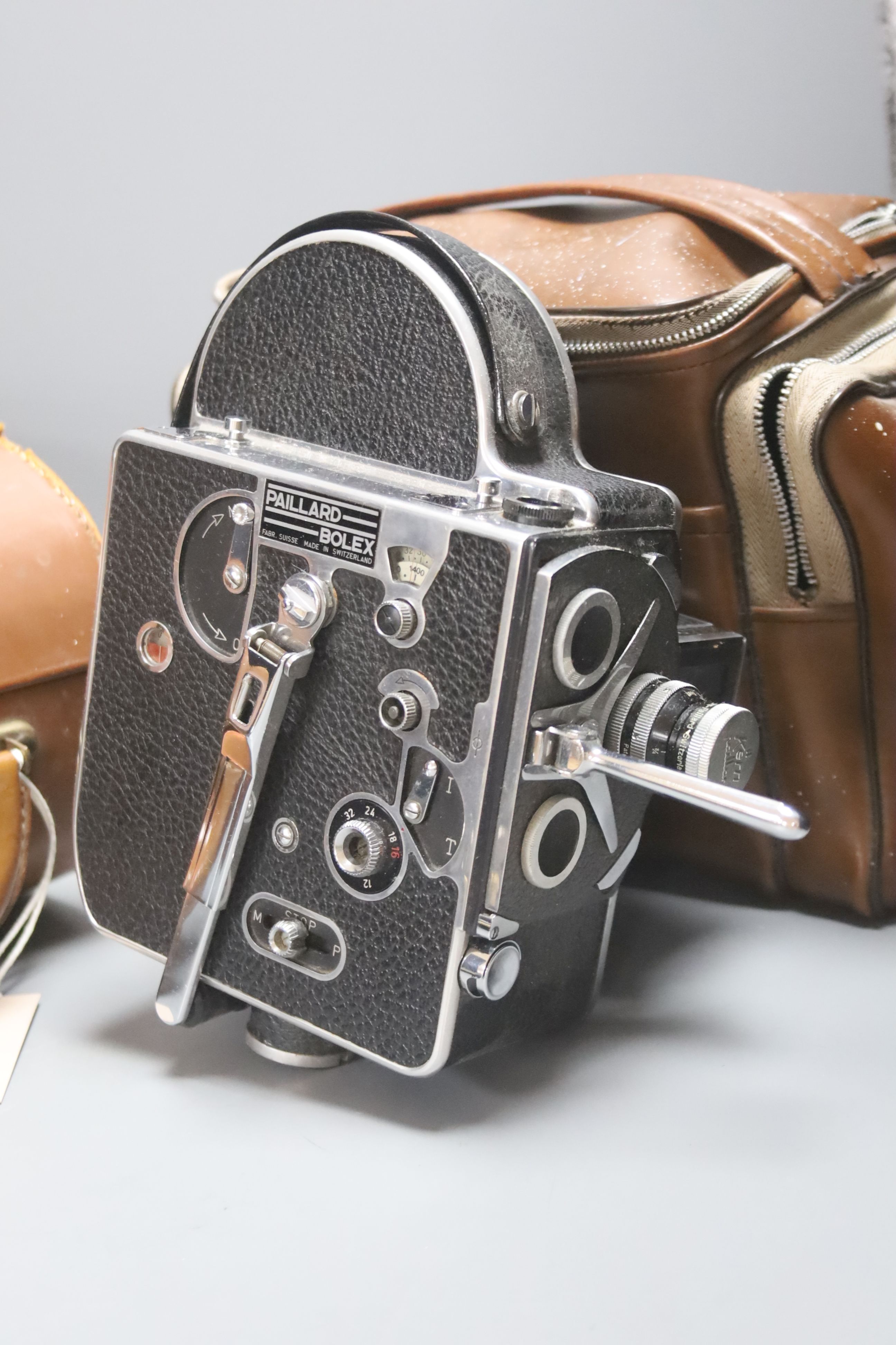 A Canon AE-1 camera serial number 4397305 with a Vivitar macro focusing lens, together with a Paillard Rolex camera